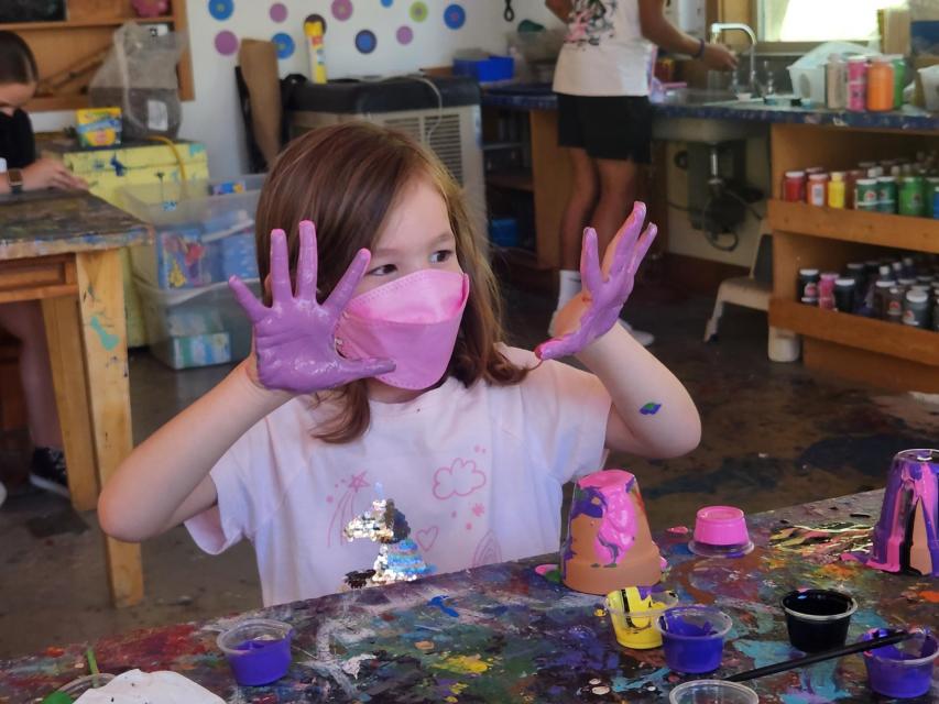 Camper with purple hands in arts and crafts, pure joy! 
