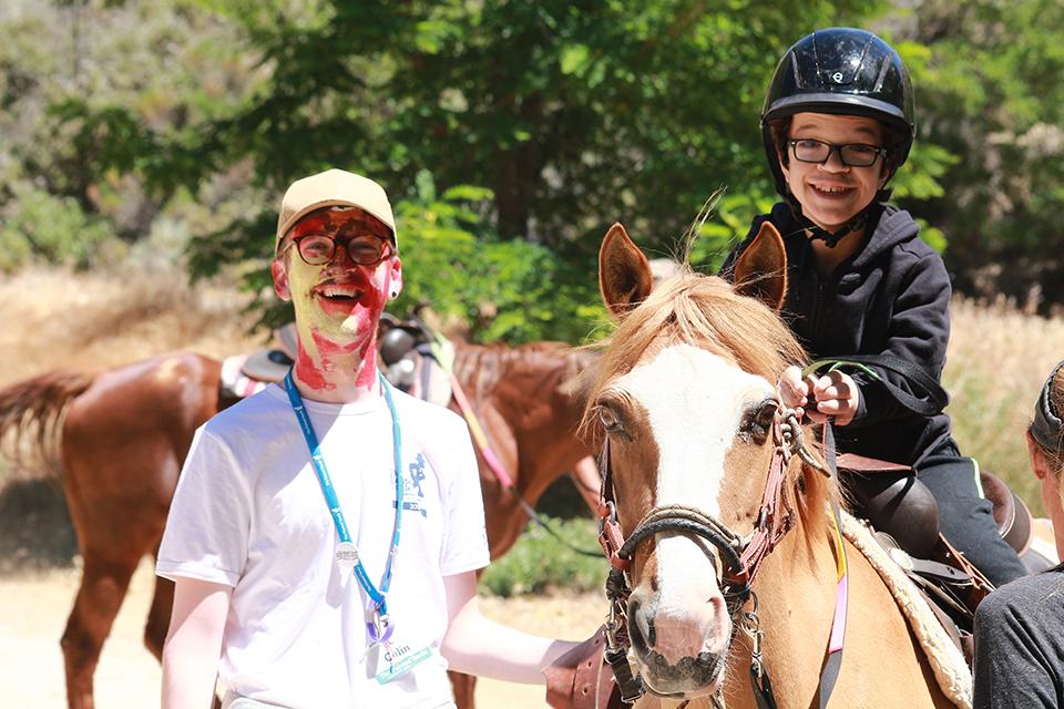 Boy on horseback with Counselor